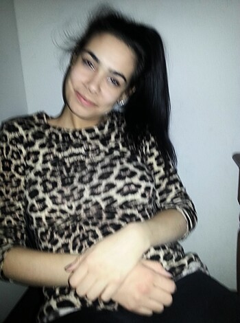 This fucking chick has a hot leopard print top on, with her hair tied up like a slutty bitch. Check out how she's restin' her tits on her arm while lookin' all sexy and shit!
