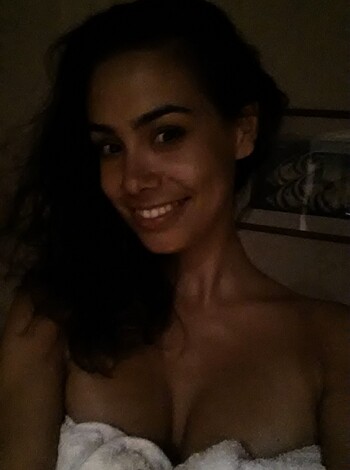 Cleavage-showing babe in white towel.