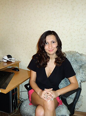 A babe is sitting on a fucking chair with her shit-hole legs crossed like a ho.