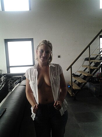 "Topless babe in white tee and denim giving the middle finger."