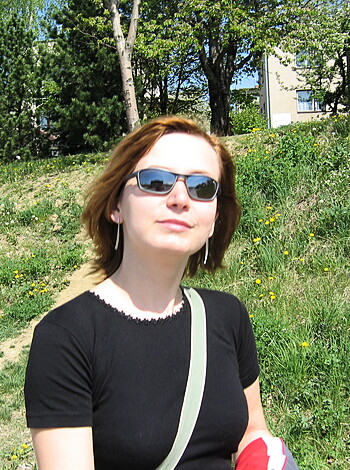 Here's a fucking hot chick with shades and a black tee, sucking on her thumb like she got some good dick last night.