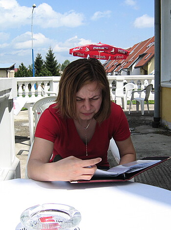 A bitch is sittin' at a fucking table, readin' a goddamn book.