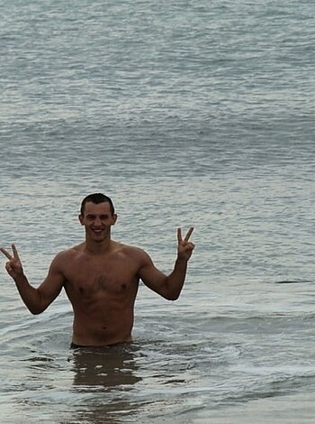"Check out this fuckin' dickhead flexin' his biceps on the sandy shore."