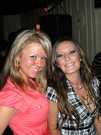 Look at these two hot bitches, dressed up real sexy-like, makin' that grinning face for the camera like they actually give a fuck about it. I mean, who are they even trying to impress? Probably some dude with a small dick who couldn't handle either of 'em anyway.