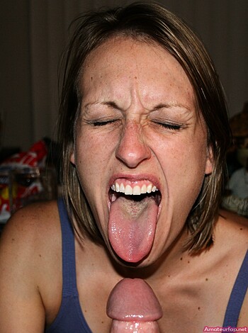 Vulgar description of the image: A guy's dick is going down a chick's throat while she has her tongue wagging around like a wild beast.