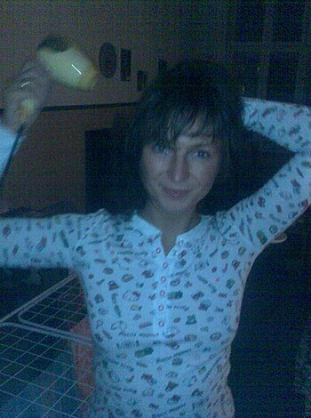 A sexy babe wearing PJs is clutching a fuckin' banana while grinnin'.