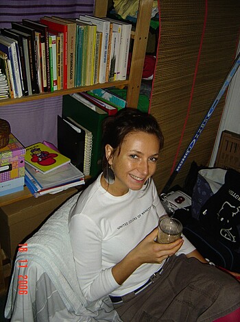 A busty blonde chick sips her coffee while posing for the camera with a cheeky grin on her face in this fuckin' pic taken inside her home.