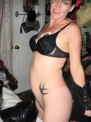 A chick wears a bra and thong, showing off her tits.