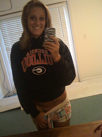 "Sexy-ass chick with tight panties and a cozy sweatshirt, getting freaky on the couch."
