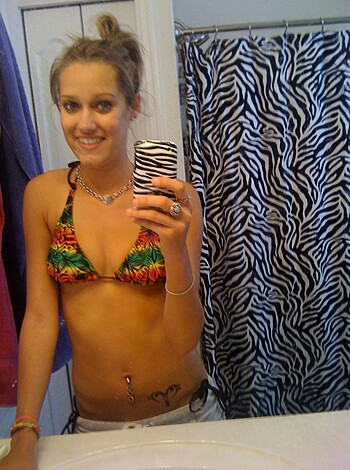 "Smile, bitches! Check out this hot blonde chick with the massive tits admiring herself in the mirror."