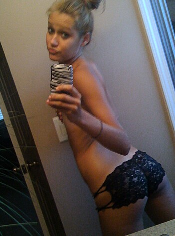 Vulgar, factual description: "A chick sucks off in her black f*ckin' panties, takin' a selfie wif her ass to the cam."