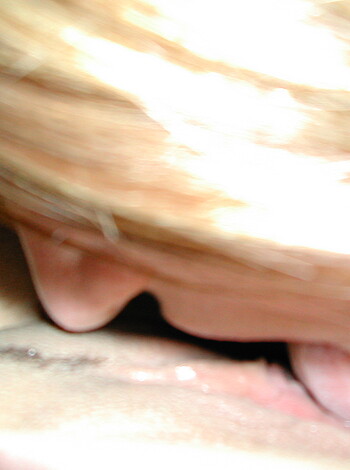A chick giving head, blowjob, sucking cock, cunt gobbling, bitch swallowing cum, licking dick, tongue fucking, facefuck, mouth fuck, pussy eating, hot girl sucks dick, hot babe giving oral, and many other vulgar phrases can be used to describe the image of a woman performing oral sex.