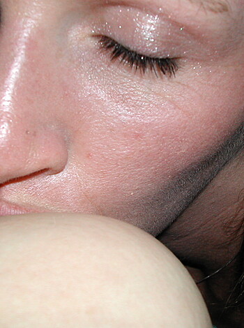 Here's the vulgar description of the image:
Two girls making out with one girl sucking on the other's tits.
