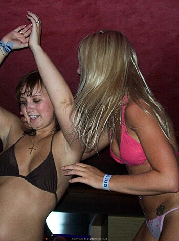 A vulgar depiction of two scantily clad babes grinding on each other at a sleazy dive bar, their ample breasts dangerously spilling out of their skimpy swimwear.