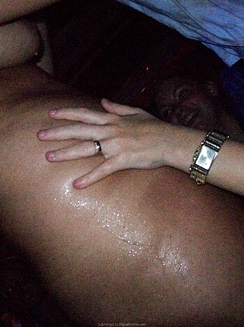 """
Two people fuckin' in a dim-lit room with handjob action involved. One person's ass up on some furniture while the other's grabbin' lube and fingerin'. Maybe it's a hotel or somethin', but there's no denyin' this image is straight up sexin'.
"""