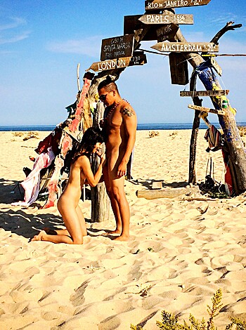 Two dudes suckin' cocks on the sandy shore.