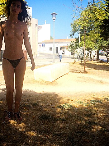 This naked bitch is sprawled out on her fuckin' hands and knees like a dirty slut, soakin' up the rays in some goddamn public park.
