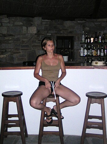 "Bare-assed babe perched on a barstool."
