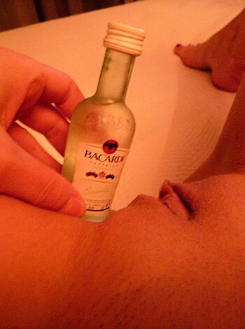"Here's a close-up of a hard dick with beer dangling from it."