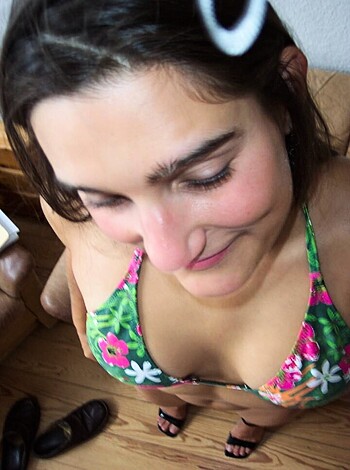 "A hot bitch squeezing her tits while staring at them, like a total tit-masher."