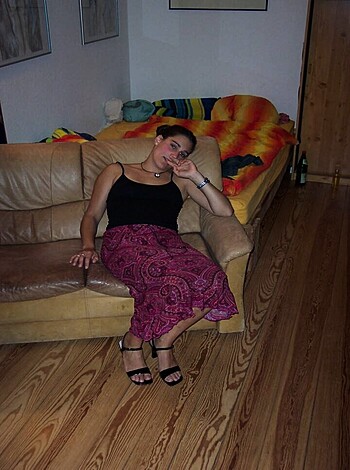 "This picture of a bitch is lying on some fuckin' couch, dressed in a tight little black shirt and sexy ass red skirt."
