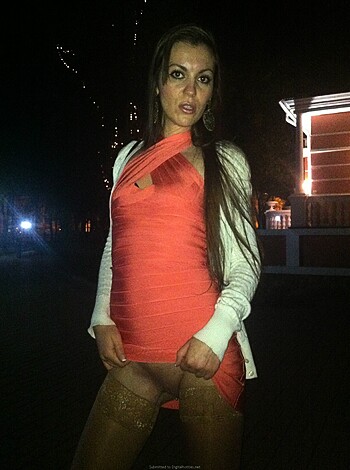 """
The girl is sporting a crimson outfit and has her palm on her pussy.
"""