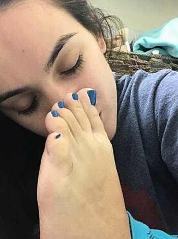 Vulgar description: "Mouth-to-feet blowjob by lady on babe's stanky gym shoes."