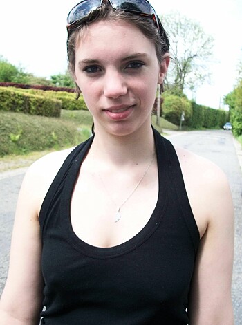 Vulgar Description: "Here's a photo of a hot young chick, with her tits poppin' out of her tight-ass tank top and shades on her face."