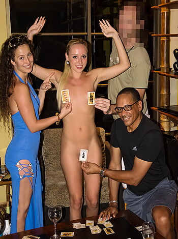 A scantily clad busty chick sits on her ass cheeks, showing off her long blonde locks while holding a deck of cards and spreading them out seductively for your viewing pleasure.