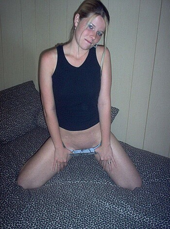 "This picture shows a chick with her tits and pussy hanging out while she sits on a bed in some cheap ass underwear."